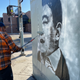 Unlicensed street art is removed outside an Andrew Yang pop-up event in Los Angeles.